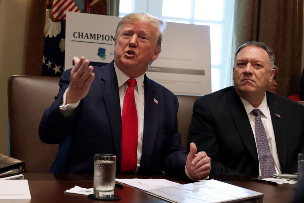 PHOTO: U.S. President Donald Trump speaks as Secretary of State Mike Pompeo listens during a cabinet meeting in the Cabinet Room of the White House October 21, 2019 in Washington, DC.