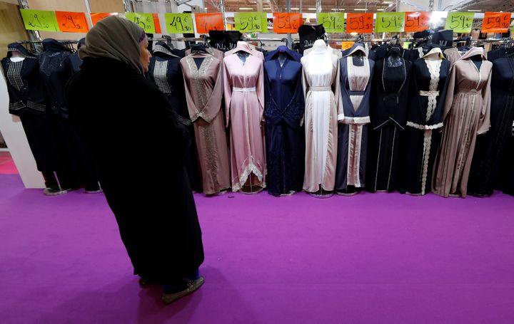 A visitor looks at women's clothes during a meeting organized by the Union of Islamic Organizations of France at Le Bourget, 