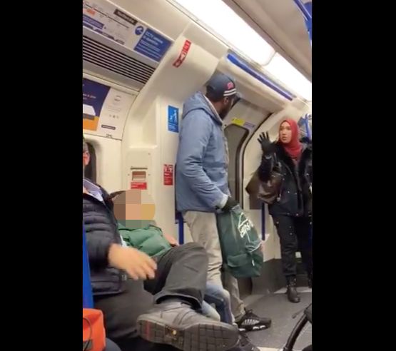 Asma Shuweikh speaks to a man on a London subway car who is accused of harassing a Jewish family.