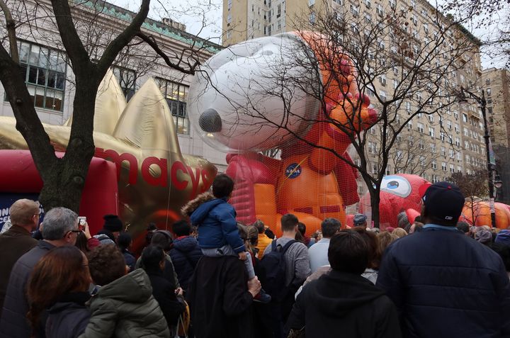 People walk past the Astronaut Snoopy balloon after it was inflated for the annual Macy's Thanksgiving Day Parade in New York