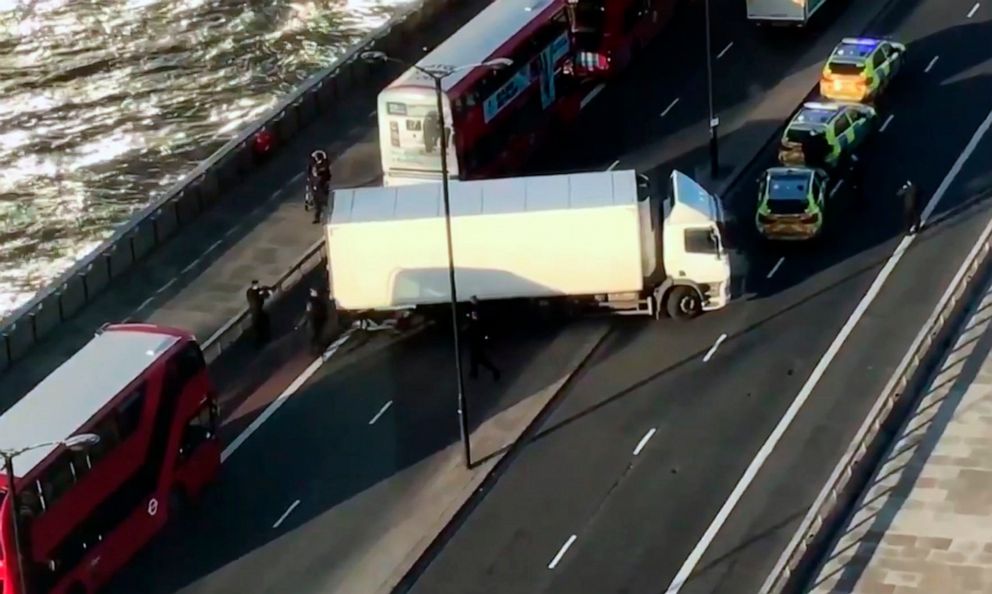 PHOTO: In this image made from video provided by Luke Poulton, armed police surround a truck parked across lanes of traffic on London Bridge, following an incident in central London, Nov. 29, 2019.