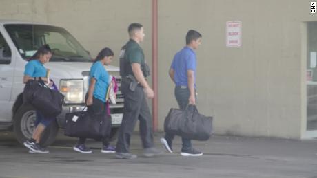 Deisi, far left, walks with other migrants to a Texas bus station to begin her journey north.