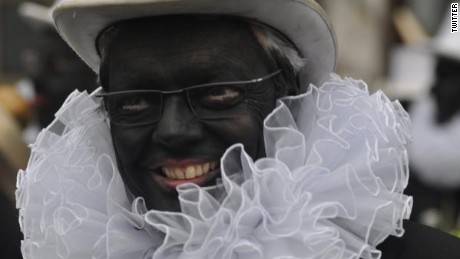 Belgian Foreign Minister Didier Reynders gives a TV interview while wearing blackface.