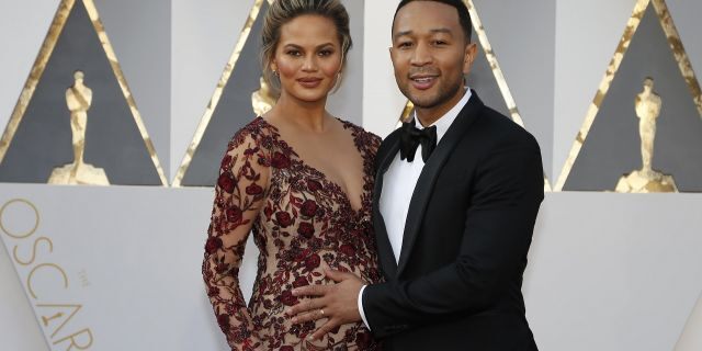 Model Chrissy Teigen poses with husband John Legend, who controversially reworked "Baby, It's Cold Outside."