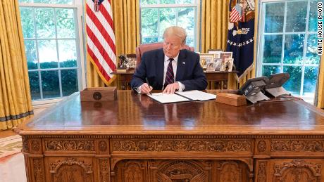 In this White House photo, President Donald Trump signs an executive order on September 19, 2019 to modernize the flu vaccine.