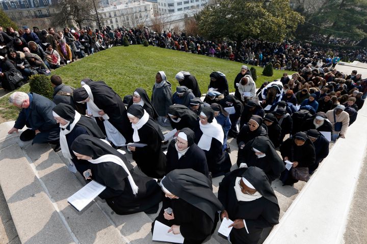 Catholic nuns attend the annual Good Friday "Stations of the Cross" procession in the gardens of the Montmartre's Sacre Coeur