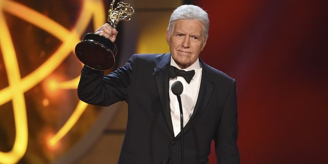 Alex Trebek accepts the award for outstanding game show host for "Jeopardy!" at the 46th annual Daytime Emmy Awards.