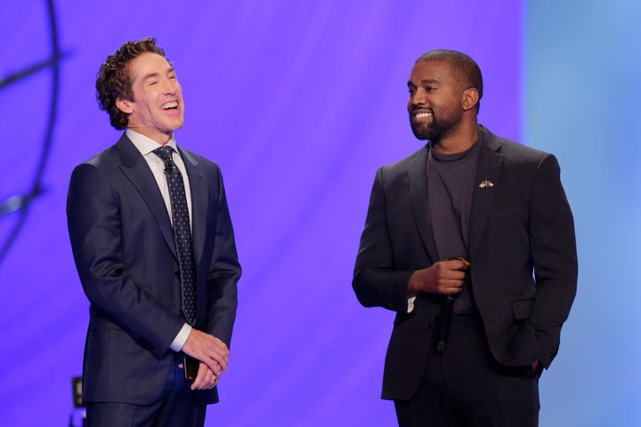 Kanye West, right, answers questions from senior pastor Joel Osteen, left, during a service at Lakewood Church, Sunday, Nov. 