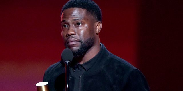 Pictured: Kevin Hart accepts The Comedy Act of 2019 award on stage for 'Kevin Hart: Irresponsible' on stage during the 2019 E! People's Choice Awards.