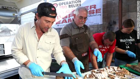 Matthew McConaughey helping prepare barbecue for firefighters battling California&#39;s wildfires on Friday. 