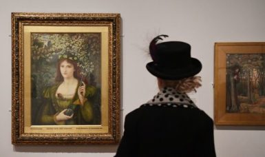 A visitor looks at "Sestina of the Lady Pietra degli Scrovigni" by Dante Alighieri at London's National Portrait Gallery