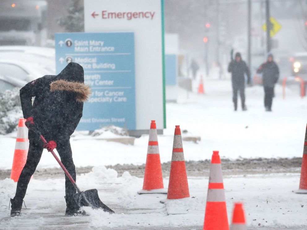 PHOTO: A worker shovels snow from a sidewalk, Nov. 11, 2019, in Chicago.