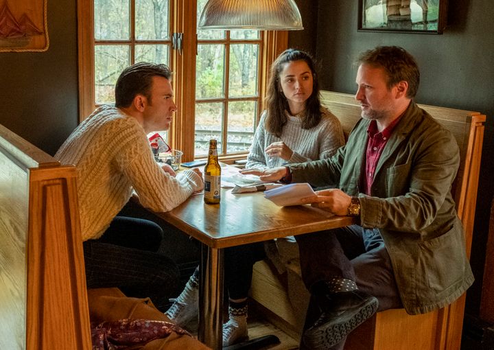 Rian Johnson (right) directs Chris Evans and Ana de Armas in a scene from "Knives Out."
