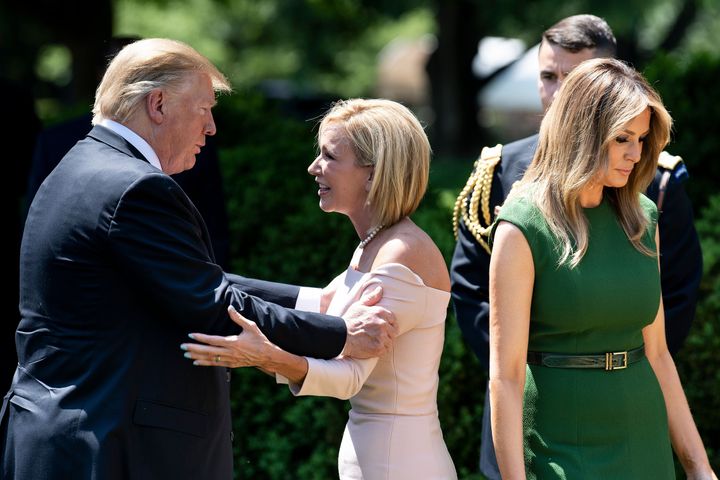 President Donald Trump talks to Pastor Paula White after an event to celebrate a national day of prayer at the White House on