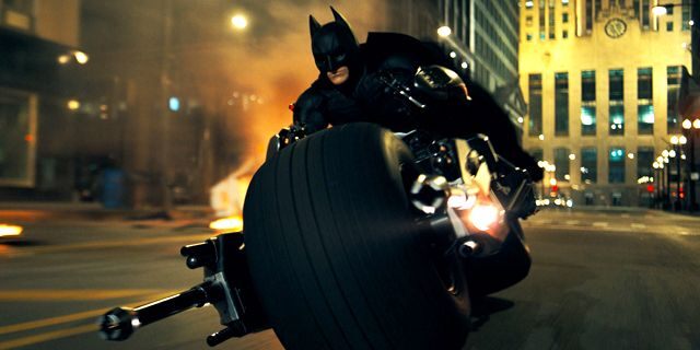 Christian Bale rides a very custom chopper as Batman in a scene from "The Dark Knight."