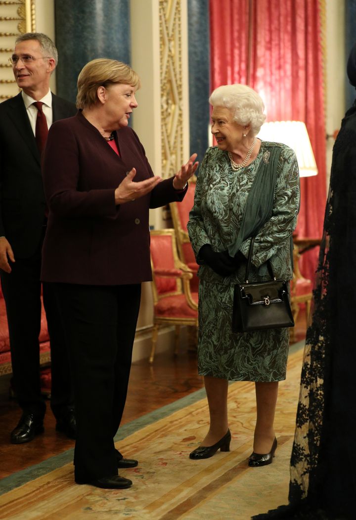 Queen Elizabeth talks with German Chancellor Angela Merkel.&nbsp;