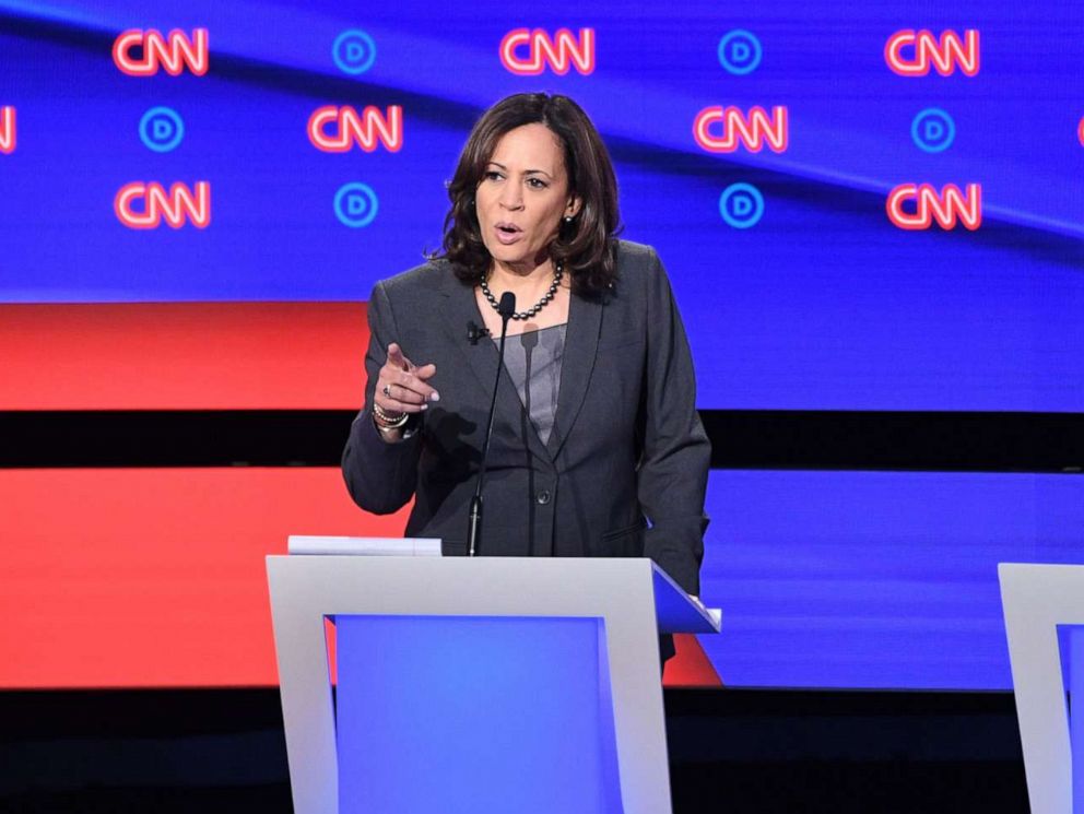 PHOTO: Kamala Harris delivers her closing statement flanked by Joe Biden and Andrew Yang during the second round of the second Democratic primary debate in Detroit, Michigan on July 31, 2019.