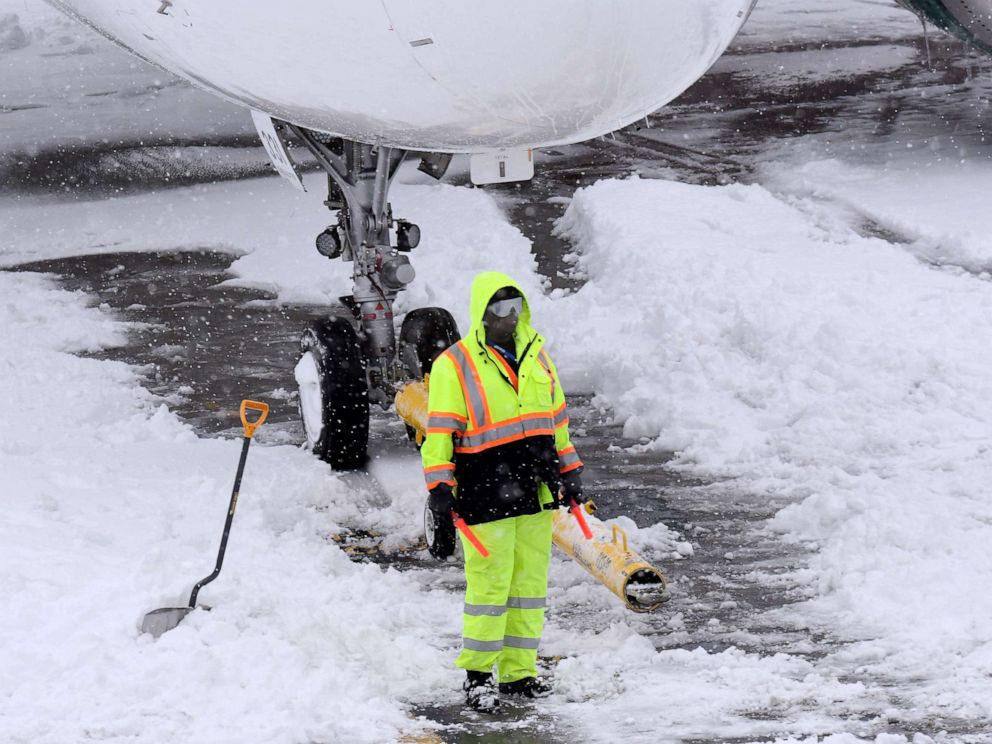 PHOTO:Ground crews remove snow from the airport tarmac as flights resume after an overnight snowfall, at the Albany International Airport in Colonie, N.Y., Dec. 2, 2019.