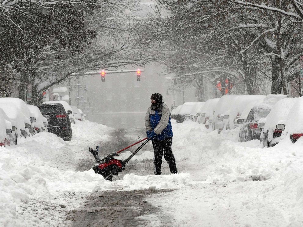 PHOTO: Mike Coutsonikas, spends the day earning extra money helping people dig out their cars and clear sidewalks on State street after an overnight snowfall, in Albany, N.Y., Dec. 2, 2019. 