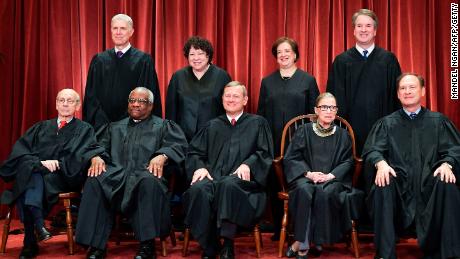 Justices of the US Supreme Court pose for their official photo in Washington on November 30, 2018. Standing from left: Associate Justice Neil Gorsuch, Associate Justice Sonia Sotomayor, Associate Justice Elena Kagan and Associate Justice Brett Kavanaugh.Seated from left to right, bottom row: Associate Justice Stephen Breyer, Associate Justice Clarence Thomas, Chief Justice John  Roberts, Associate Justice Ruth Bader Ginsburg and Associate Justice Samuel Alito.