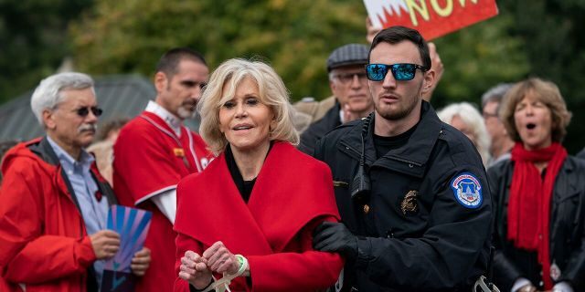 In this Friday, Oct. 25, 2019, actress and activist Jane Fonda is arrested at the Capitol for blocking the street after she and other demonstrators called on Congress for action to address climate change.