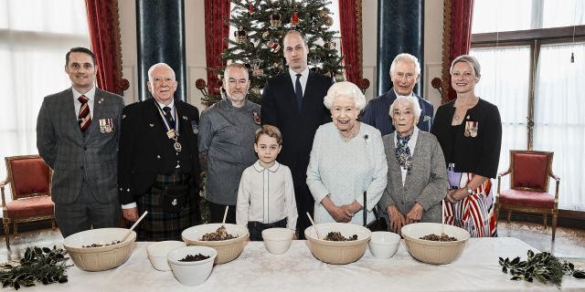 Queen Elizabeth, Prince Charles, Prince William and Prince George, alongside, from left, veterans Liam Young, Colin Hughes, Alex Cavaliere, Barbra Hurman and Lisa Evans,at the launch of The Royal British Legion's Together at Christmas initiative. (Chris Jackson/Buckingham Palace via AP)