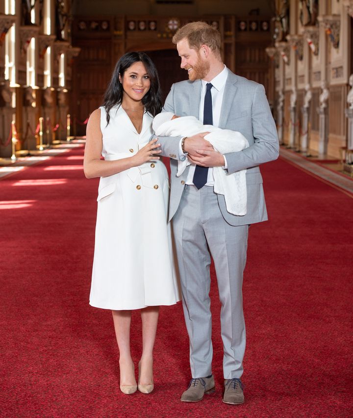 Meghan and Harry pose with their newborn son Archie Harrison Mountbatten-Windsor in St George's Hall at Windsor Castle on May 8 in Windsor, England.