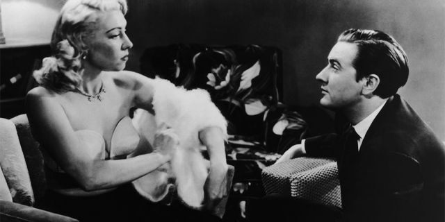 Edward D. Wood Jr. (1924 - 1978) watches actress Dolores Fuller remove her white angora sweater in a still from the film "Glen Or Glenda," 1953.