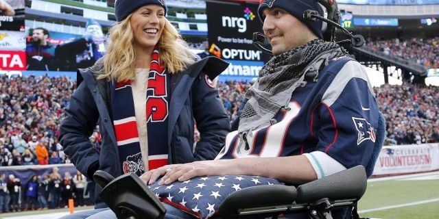 In this Dec. 28, 2014, file photo, Julie and Pete Frates smile on the sideline at Gillette Stadium during a birthday ceremony for Pete at an NFL football game between the New England Patriots and the Buffalo Bills in Foxborough, Mass. (AP Photo/Elise Amendola, File)