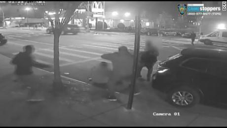 A still image from a surveillance video shows two men being attacked and robbed in the Bronx.