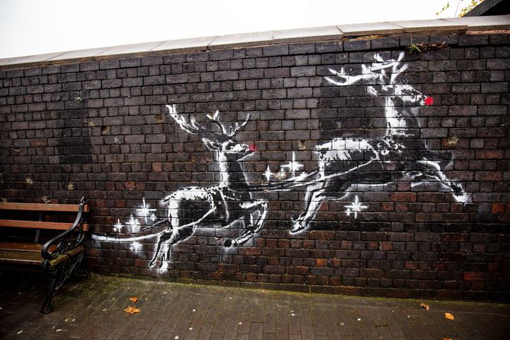 The Banksy mural in Birmingham shows two painted reindeer appearing to pull along a real bench.