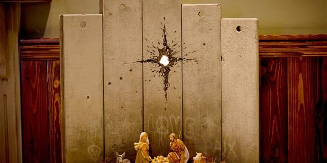 A new artwork dubbed "Scar of Bethlehem" by the artist Banksy is displayed in The Walled Off Hotel, in the West Bank city of Bethlehem, Sunday, Dec. 22, 2019. (AP Photo/Majdi Mohammed)