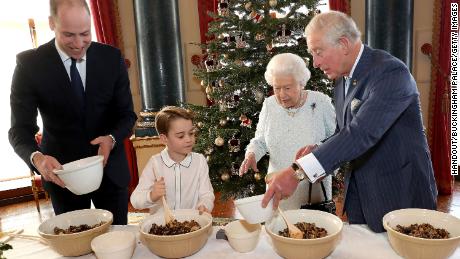 Prince George joins his father, Prince William, Queen Elizabeth and Prince Charles to bake Christmas puddings to support to armed forces and veteran communities during the holidays. 