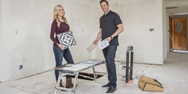 As seen on 'Flip or Flop,' real estate partners, Christina Anstead and Tarek El Moussa, pose as they pick out tiles for the kitchen of this Yorba Linda, Calif. home which they are hoping to flip for a profit.