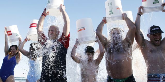 People take the ice bucket challenge during the last "Plunge for Pete" event on what would have been Pete Frates' 35th birthday, at Good Harbor in Gloucester, Mass., on Dec. 28. (John Blanding/The Boston Globe via AP)