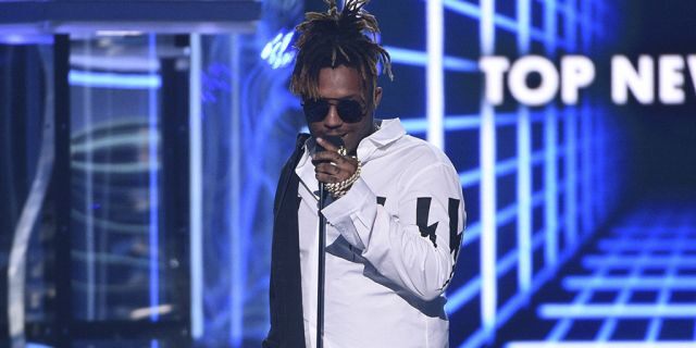 FILE - In this May 1, 2019 file photo, Juice WRLD accepts the award for top new artist at the Billboard Music Awards at the MGM Grand Garden Arena in Las Vegas. The Chicago-area rapper, whose real name is Jarad A. Higgins, was pronounced dead Sunday, Dec. 8 after a "medical emergency'' at Chicago's Midway International Airport, according to authorities. Chicago police said they're conducting a death investigation.