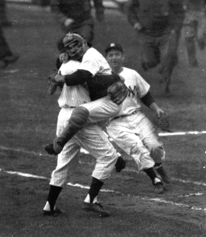 In this 1956 file photo, New York Yankees catcher Yogi Berra leaps into Don Larsen's arms at the end of Game 5 of baseball's 