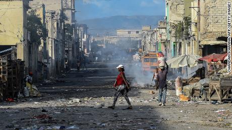 People walk in downtown  Port-au-Prince on December 20, 2019. The country&#39;s infrastructure remains in dire need of repair.