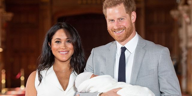 Meghan Markle and Prince Harry pose with Archie after his birth.