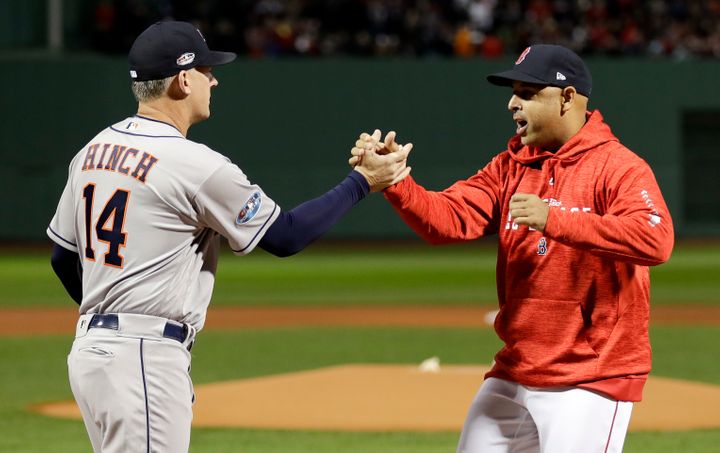 Houston Astros manager AJ Hinch, left, and Boston Red Sox manager Alex Cora shake Hanes before Game 1 of a baseball American 