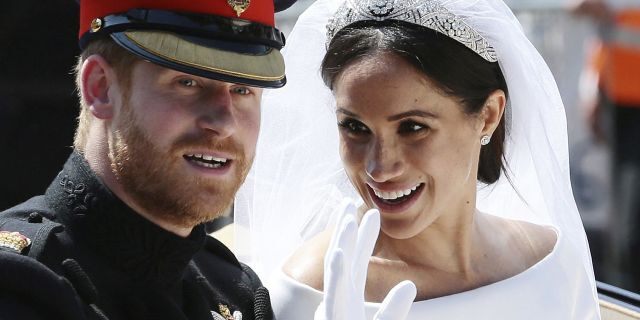 Prince Harry and Meghan Markle ride in an open-topped carriage after their wedding ceremony at St. George's Chapel in Windsor Castle in Windsor, near London, England.