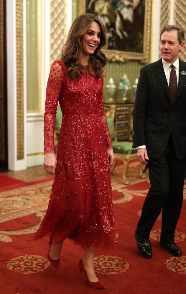 The Duchess of Cambridge walks through to the State Room with the master of the household.