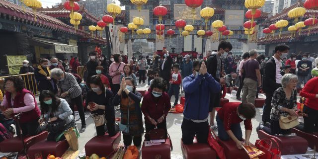 People pray at the Wong Tai Sin Temple, in Hong Kong, Saturday, Jan. 25, 2020 to celebrate the Lunar New Year which marks the Year of the Rat in the Chinese zodiac.