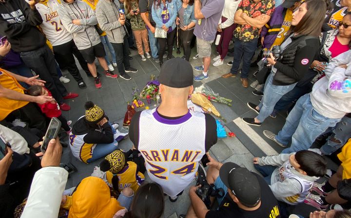 Fans mourn the loss of Kobe Bryant with makeshift memorials in front of La Live across from Staples Center, home of the Los A