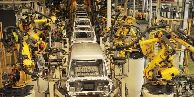 The General Motors ad features a robot from the assembly line. (Photo credit should read YU FANGPING / Barcroft Media via Getty Images)