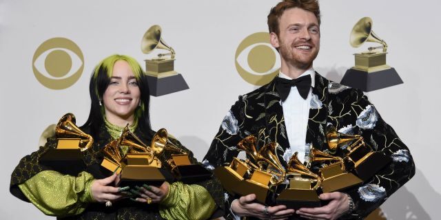 Billie Eilish, left, and Finneas O'Connell pose in the press room with the awards for best album, best engineered album and best pop vocal album for "We All Fall Asleep, Where Do We Go?," best song and record for "Bad Guy," best new artist and best producer, non-classical at the 62nd annual Grammy Awards at the Staples Center on Sunday, Jan. 26, 2020, in Los Angeles. 