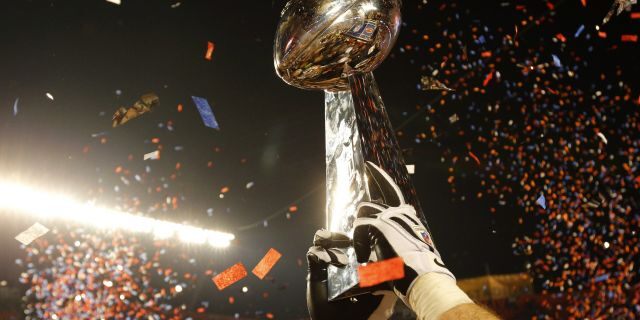 The Vince Lombardi Trophy is lifted into the air after the New Orleans Saints defeated the Indianapolis Colts in the NFL's Super Bowl XLIV football game in Miami, Florida, February 7, 2010. 