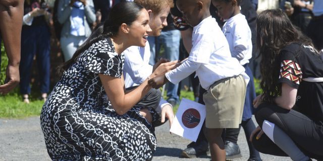 Prince Harry and Meghan Duchess of Sussex greet children on their arrival at the Nyanga Methodist Church in Cape Town, South Africa, in Sept. 2019.