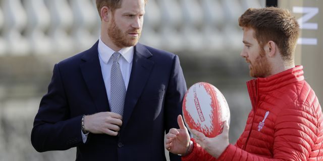 Prince Harry listens to Rugby League World Cup 2021 ambassador James Simpson in the gardens at Buckingham Palace in London, Thursday, Jan. 16.