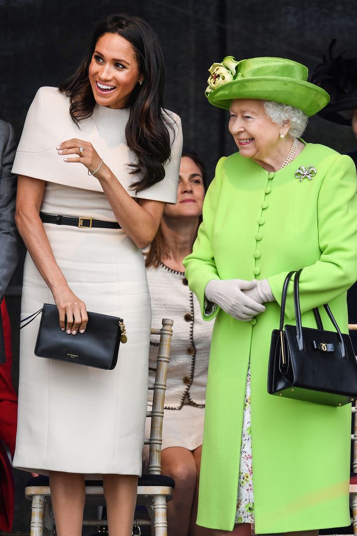 The queen stands with the Duchess of Sussex during a ceremony to open the new Mersey Gateway Bridge on June 14, 2018.